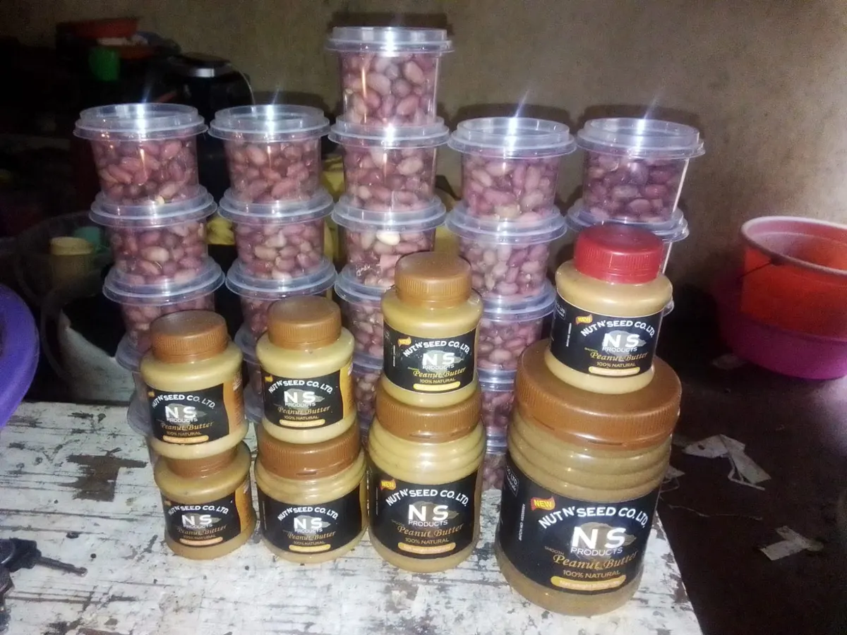 Jars of NS Products peanut butter with tubs of roasted peanuts